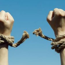 100989552-hands-tearing-shackles-the-background-of-blue-sky-concept-of